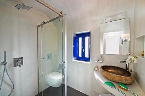 a bathroom with a large sink and a shower at Domus Solis Luxury Villa in Oia
