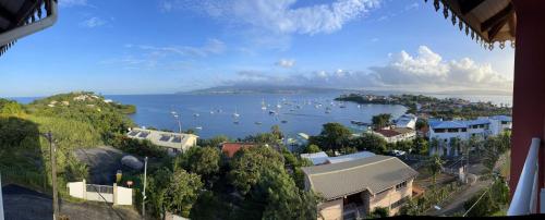a view of a harbor with boats in the water at Appartement La Cannelle in Les Trois-Îlets