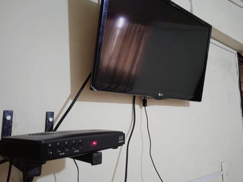 a television hanging on a wall with a keyboard at Hotel Estación Central in Lima