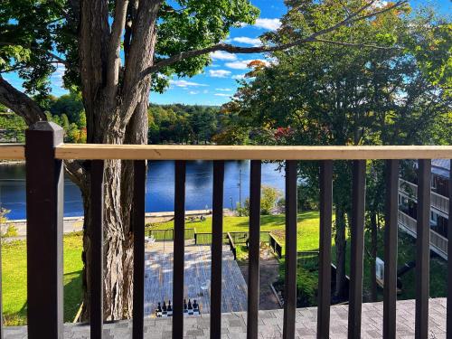a balcony with a tree and a view of the water at Inn at the Falls in Bracebridge