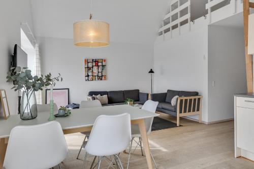 a kitchen and living room with a table and chairs at Skagen Harbour Apartments in Skagen