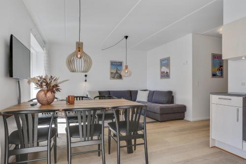 a kitchen and living room with a table and chairs at Skagen Harbour Apartments in Skagen