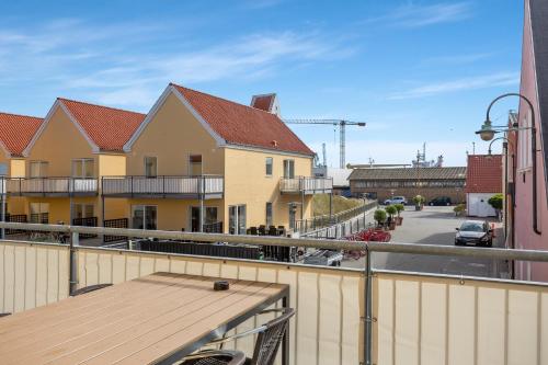 a balcony with a view of a street and buildings at Skagen Harbour Apartments in Skagen