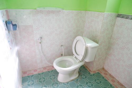 a bathroom with a white toilet in a room at Song Lao Guesthouse in Thakhek