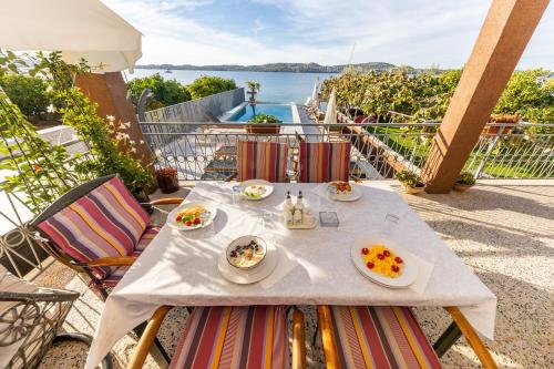 a table with plates of food on a balcony at Apartments Sea in Trogir