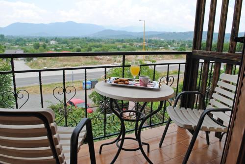 a table with a tray of food on a balcony at Hotel Aoos in Konitsa