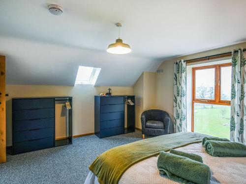 a bedroom with a large bed and a window at Yr Hen Feudy At Pentre Farm in Llansilin