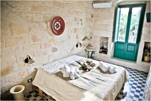 a bedroom with a bed with two stuffed animals on it at Lazzarella B&B in Polignano a Mare