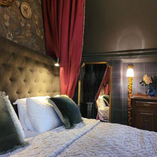 a bedroom with a bed and a red curtain at Glencruitten House in Oban