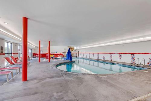 ラブランドにあるComfort Suites Lovelandの建物内の赤柱の大型スイミングプール