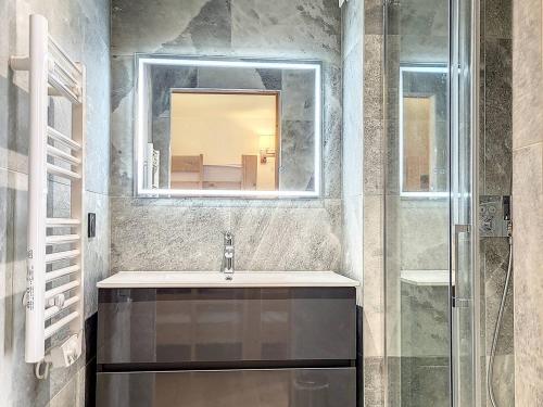 a bathroom with a sink and a mirror at Appartement Montvalezan-La Rosière, 5 pièces, 9 personnes - FR-1-275-184 in La Rosière