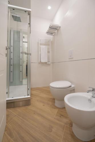 a bathroom with a toilet and a sink and a shower at Behome202 in Fisciano