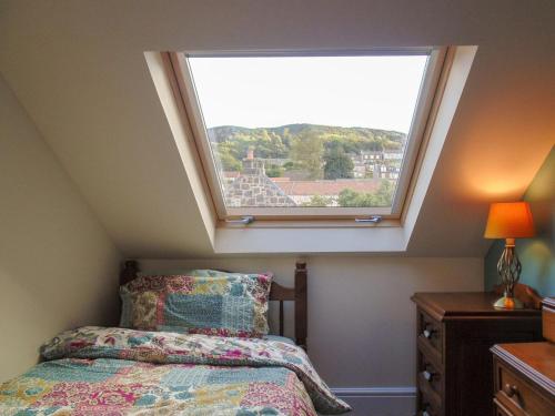 a bedroom with a large window above a bed at Newburgh C Listed Townhouse in Newburgh