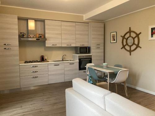 a kitchen and dining room with a table and a couch at SilverHome in Lecco