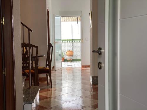 a hallway with a table and a dining room at Casa Medina in Algodonales