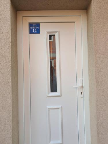 a door to a building with a sign on it at Studio Apartman 11 in Bihać