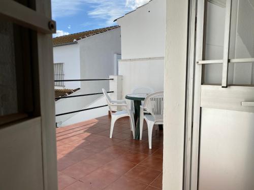 a patio with a table and chairs on a balcony at Casa Medina in Algodonales