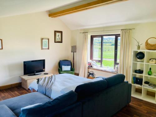 a living room with a bed and a couch at The Woodshed in Warnford