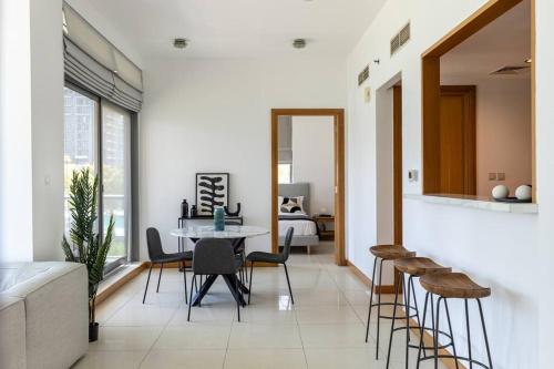 a living room with a table and chairs and a bed at Dubai Marina, Two bedrooms apartment with full Marina View in Dubai