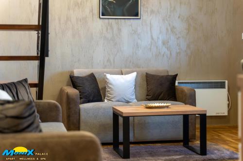 a living room with a couch and a coffee table at Monix Palace Zlatibor in Zlatibor