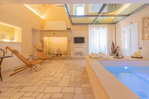 a large room with a swimming pool and a kitchen at Masseria dei Monaci in Otranto