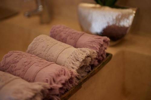 a pile of towels sitting on top of a table at Kasbah Flilou in Aït Ougliff