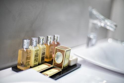 a group of bottles of oils sitting on a bathroom counter at Domus Libera in Rome