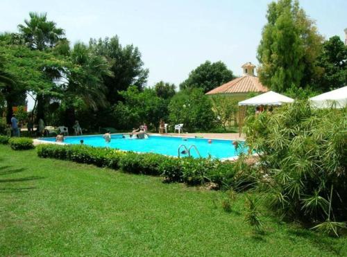 a swimming pool with people playing in it at Farmstay La Morella in Battipaglia