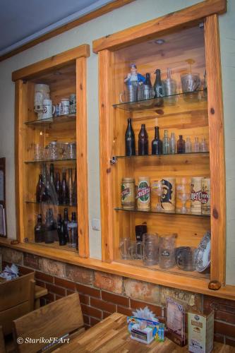 a wooden cabinet filled with lots of bottles at Hotel Almaz in Poltava
