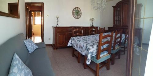 a dining room with a table and chairs in a room at Casa nel Delta del Po in Scardovari