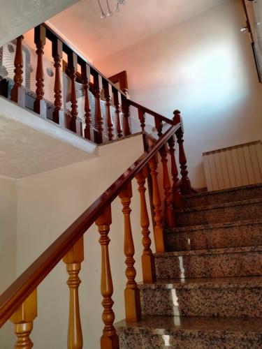 a set of stairs in a home with wooden railings at Casa nel Delta del Po in Scardovari