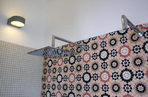 a shower curtain is hanging in a bathroom at Casa do Largo Silves in Silves
