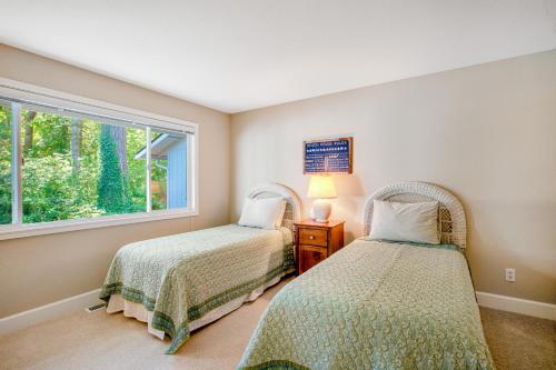 two beds in a room with a window at Sound of Sight in Allyn