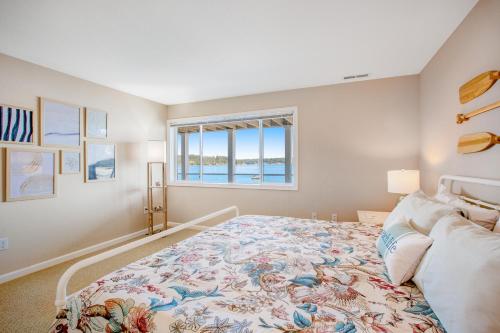 a bedroom with a large bed and a window at Sound of Sight in Allyn