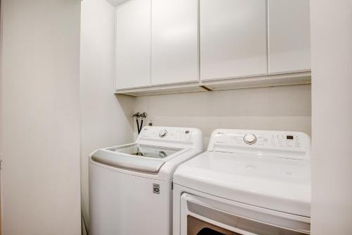 a white laundry room with a washer and dryer at Sound of Sight in Allyn