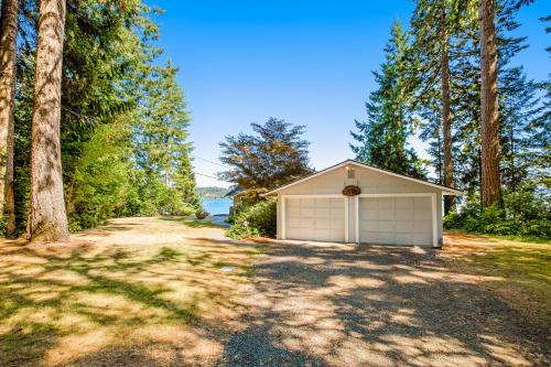a garage on the side of a road with trees at Sound of Sight in Allyn