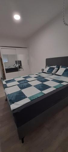 a bedroom with a bed with a checkered floor at Apartman Amor Trebinje in Trebinje