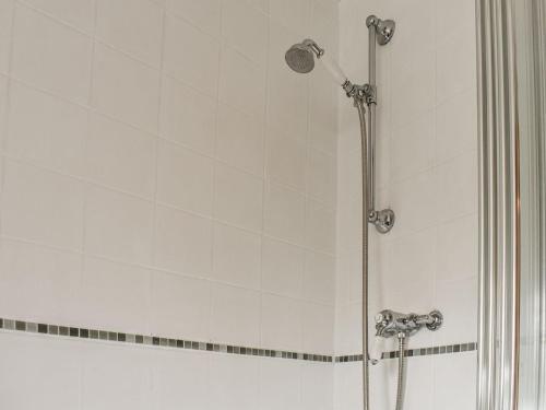 a shower with a glass door in a bathroom at Pan Cottage in Middleton