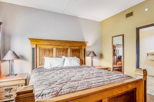 a bedroom with a large bed with a wooden headboard at Chula Vista Condo Unit 2645 in Wisconsin Dells