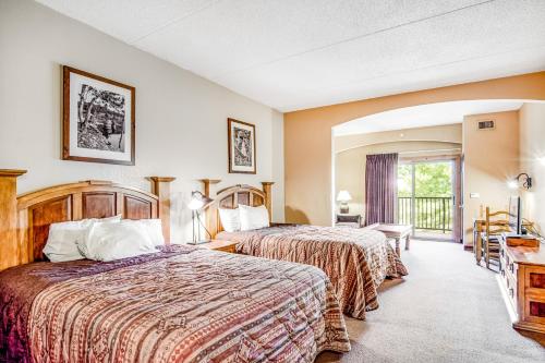 a hotel room with two beds and a balcony at Chula Vista Condo Unit 2647 in Wisconsin Dells