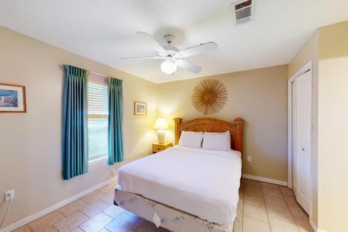 a bedroom with a bed and a ceiling fan at Grand Caribbean West 0107 in Perdido Key