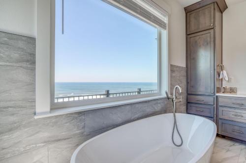 a bath tub in a bathroom with a large window at Lincoln Landing in Lincoln City