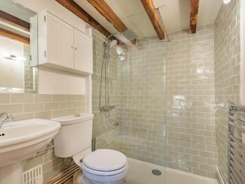 a bathroom with a toilet and a sink and a shower at The Cottage in Warborough