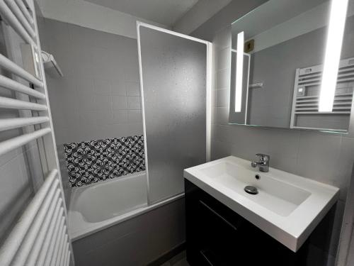 une salle de bain avec un lavabo, une douche et un miroir dans l'établissement Alcyon A23 - Studio proche pistes, à La Clusaz