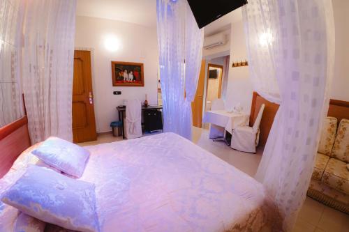 a bedroom with a large bed with a canopy at Accord Le Rose in Palagiano