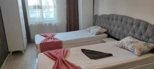 a room with two beds and a bedvisor with at Şirinevler 304 in Istanbul