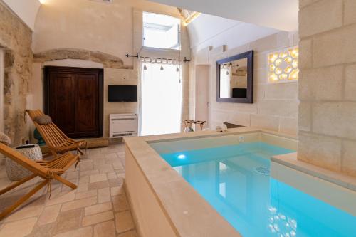 a large bathroom with a large swimming pool at Masseria dei Monaci in Otranto