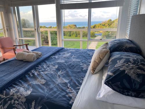 a bedroom with a bed with a view of the ocean at Seacroft Beach House in Sugarloaf