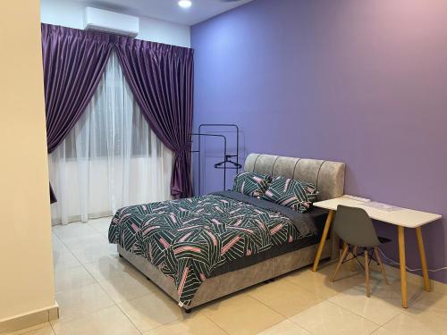 a bedroom with a bed and a table and a window at 家好月圆 Sweet Home in Kampong Seri Gading