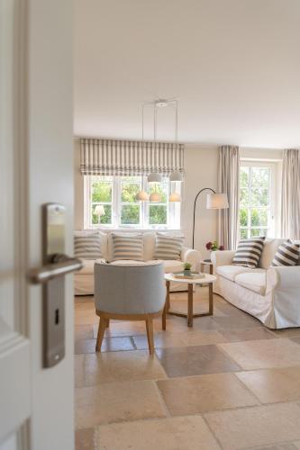 a living room with two couches and a table at Haus Deichblick 1 in Dunsum